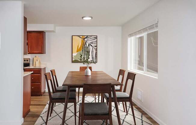 a kitchen and dining area with a carpeted floor and large window at Heritage Grove Apartments in Renton, WA