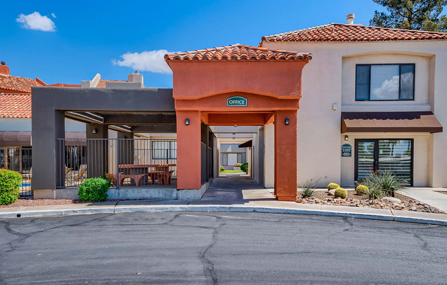a building with a porch and a street in front of it