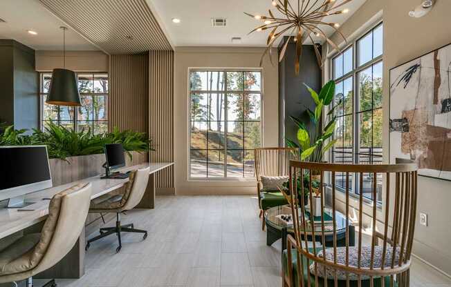 a home office with a desk and chairs and a large window