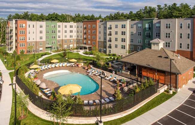 an aerial view of an apartment building and a swimming pool