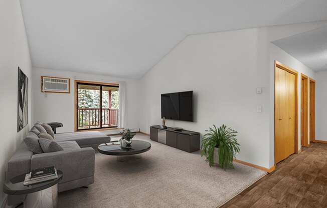 the living room of an apartment with a couch and a tv