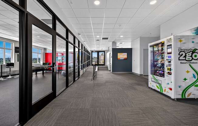 A long hallway with a vending machine on the right.