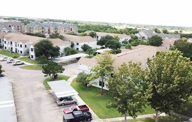 A view of a residential area with houses and cars.