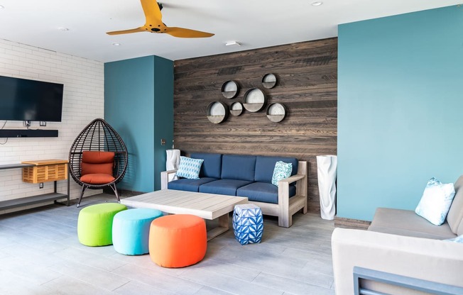 a living room with blue walls and colorful furniture