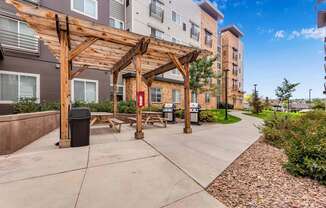 our apartments have a spacious patio with a wood pavilion and picnic tables at Parks Residential - Denver, Colorado