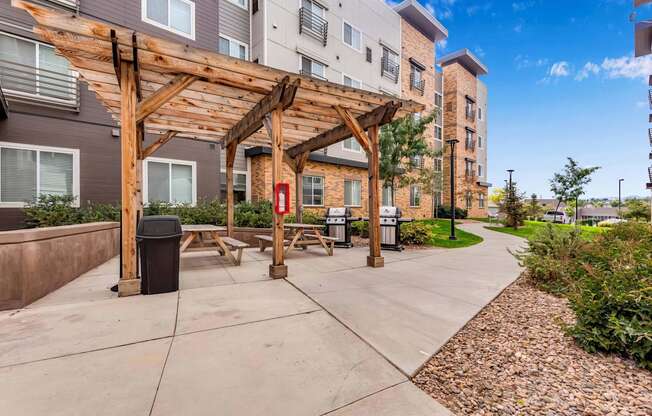 our apartments have a spacious patio with a wood pavilion and picnic tables at Parks Residential - Denver, Colorado