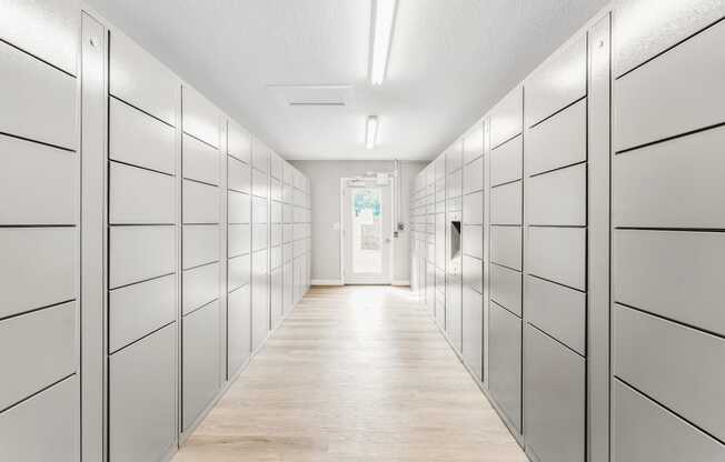 A long hallway with white lockers on both sides.