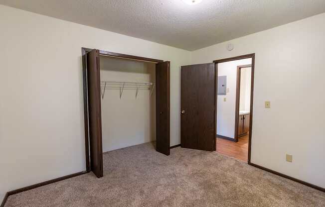 Bedroom with two closets and a carpeted floor at Parkwest Gardens West Fargo