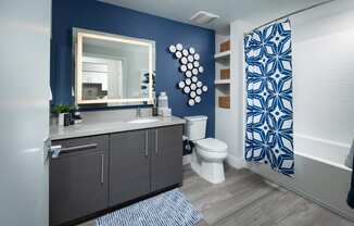a bathroom with a blue and white shower curtain