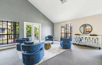 Plush blue single seat couches in two-story clubhouse at Bandera Crossing apartments in San Antonio, TX