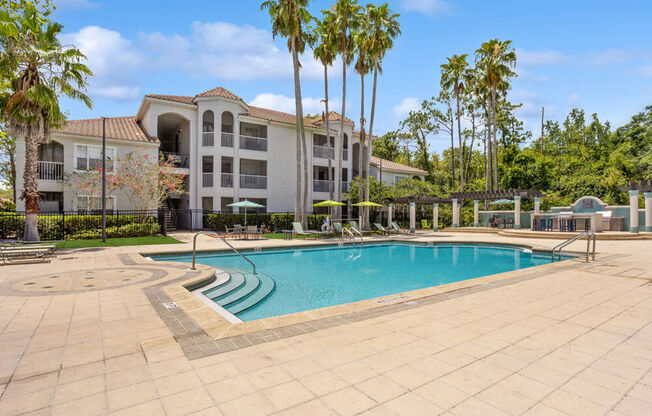 Swimming pool and pool deck with apartment building in background