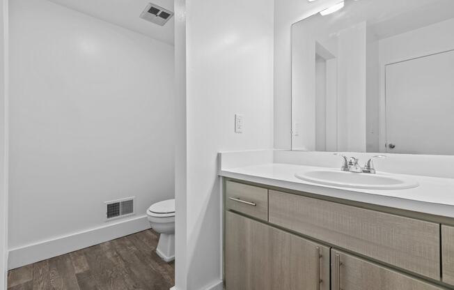 a bathroom with a sink and a toilet and a mirror at Edge At Farmington Hills - Farmington Hills, MI, Michigan, 48334
