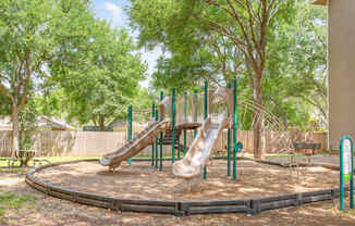a playground with two slides in a park
