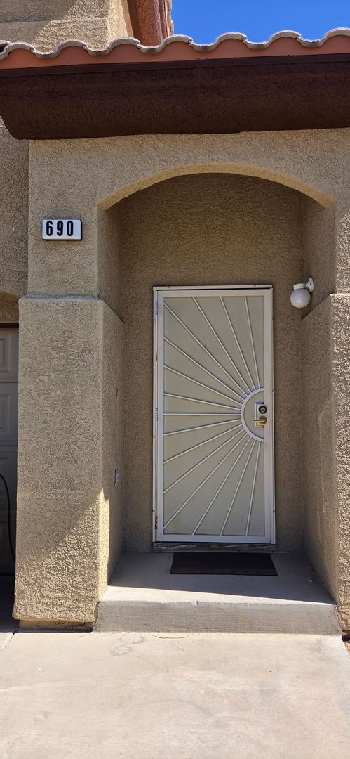 Two story 2 bedroom townhome with newer flooring, paint & appliances - community pool!