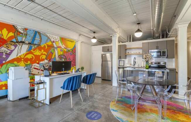 a living room with a kitchen and a table and chairs at Highland Mill Lofts, Charlotte, 28205