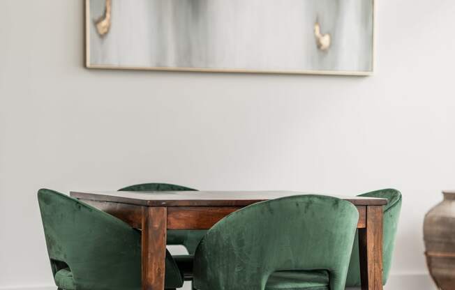 a dining room with a wooden table and green chairs
