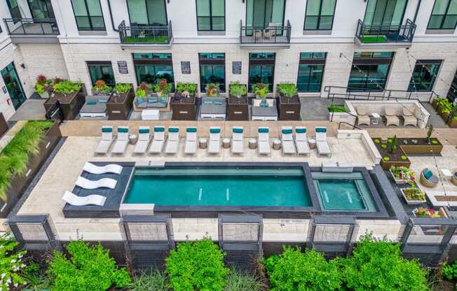 an aerial view of the pool and lounge area at the lawrenceville apartments in lawrence