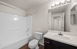 a bathroom with a sink toilet and bathtub