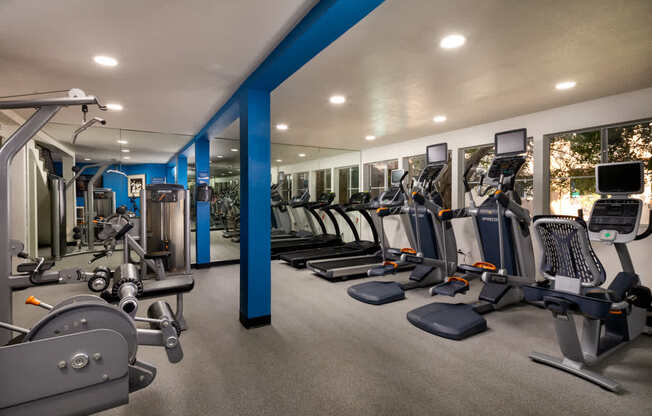 Gym with cardio equipment and weights in a building with windows at Ascend2300, Carlsbad, CA