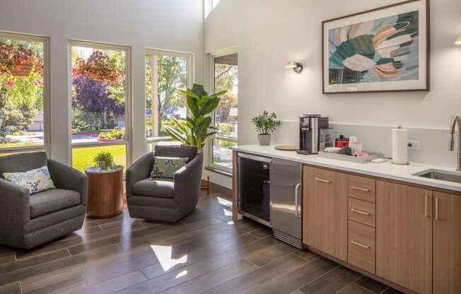 a kitchen with a sink and chairs and a window
