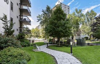 Exterior shot of winding pathway on green grass, at Prospect Place, NJ 07601
