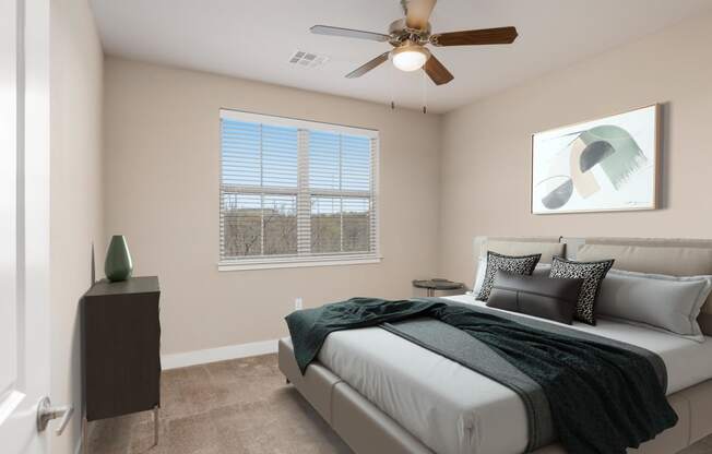 a bedroom with a bed and a ceiling fan