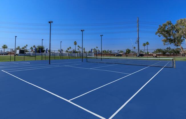 two tennis courts at the enclave at woodbridge apartments in sugar land, tx