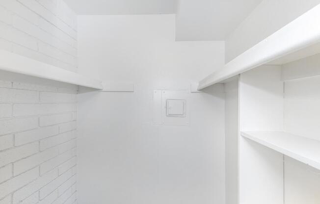 A white room with a white ceiling and white shelves.