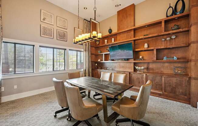 a dining room with a table and chairs and a bookshelf