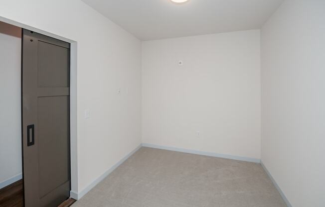 an empty room with a door to a closet at The Crossings at Windsong, Prescott Valley