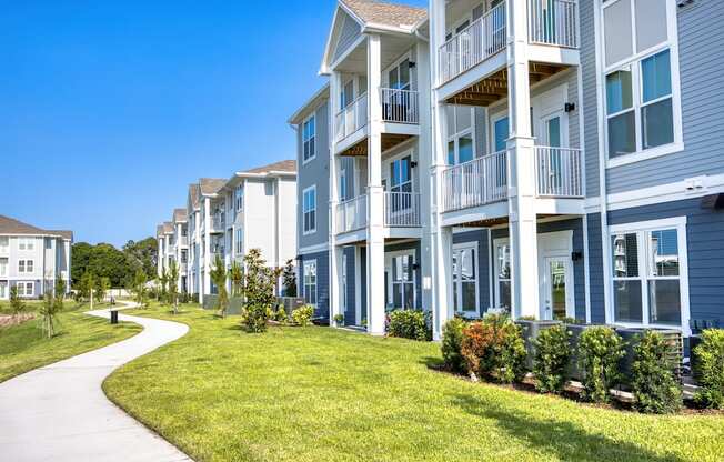 a row of houses with balconies and a sidewalk