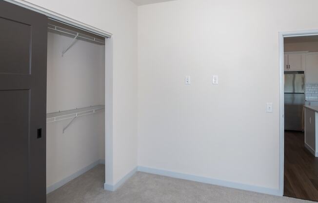 an empty bedroom with a closet and a door to the bathroom at The Crossings at Windsong, Prescott Valley