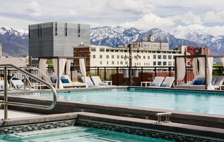 a swimming pool at a hotel with mountains in the background