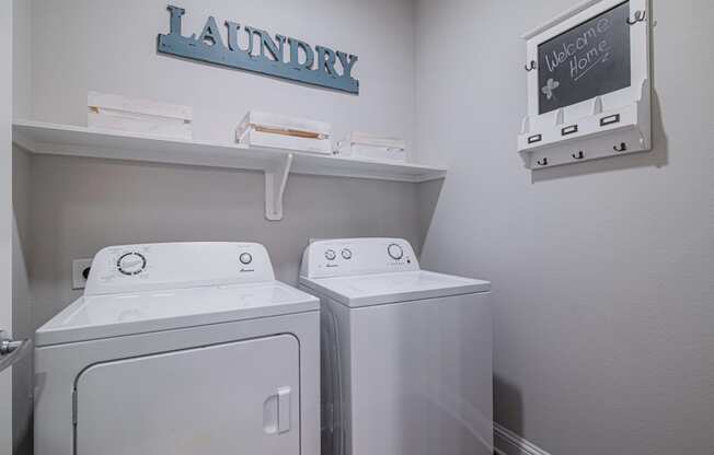 a laundry room with two washes and a dryer