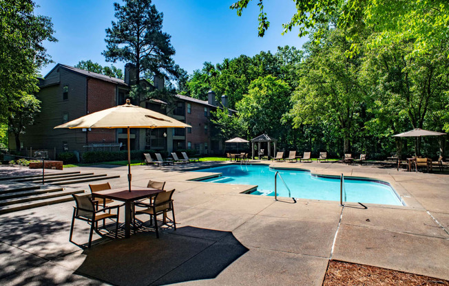 our apartments offer a swimming pool with tables and umbrellas at The Summit Apartments, Memphis, 38128