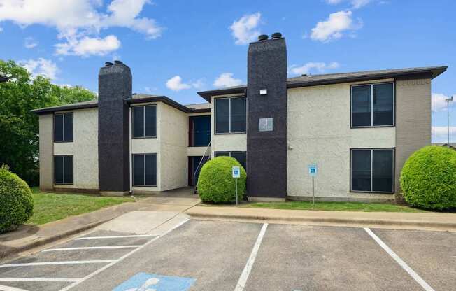 A parking lot in front of an apartment building at Heritage Square