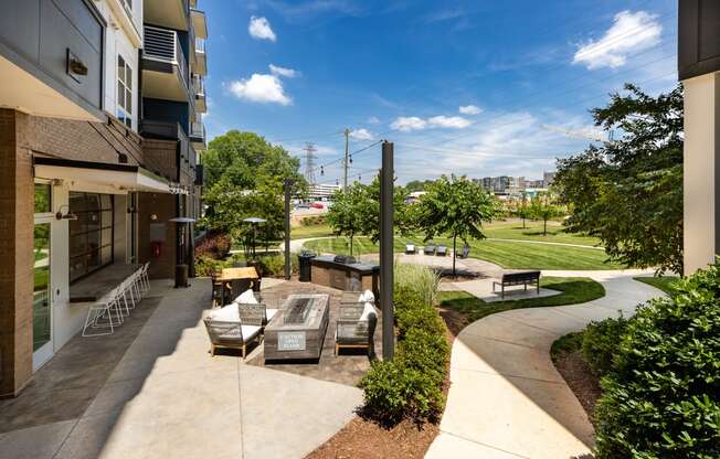 a patio with a fountain and seating area at the enclave at woodbridge apartments in sugar land  at Abberly Noda Vista Apartment Homes, North Carolina, 28206