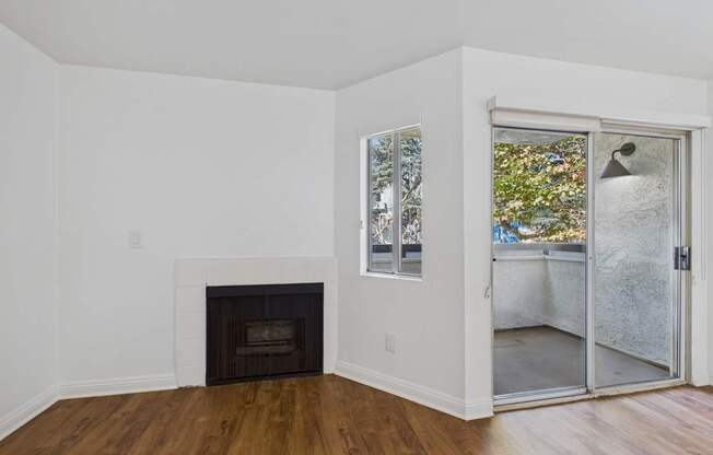 A room with a fireplace and a sliding glass door.