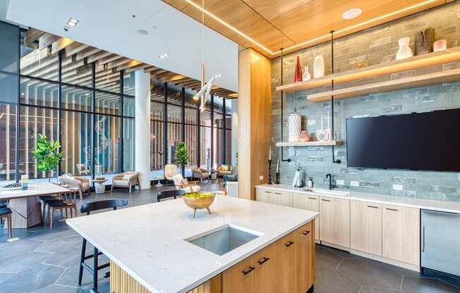 a kitchen with a counter and a sink and a television