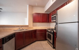 a kitchen with stainless steel appliances and wooden cabinets