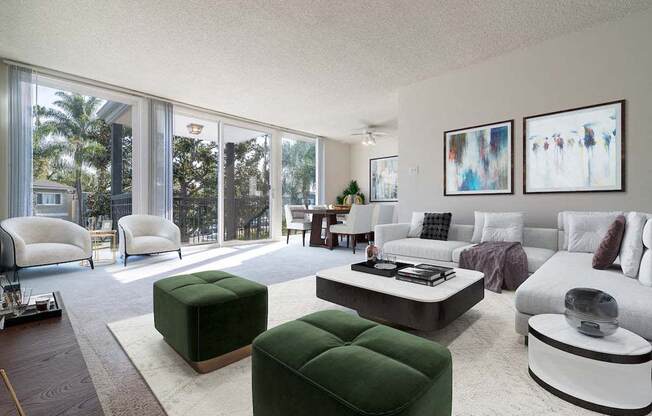 a living room filled with furniture and a large window at  Park Avenue Apartments, California