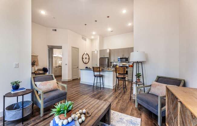 A living room with a grey couch and a wooden coffee table.