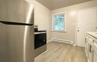 a kitchen with stainless steel appliances and a window