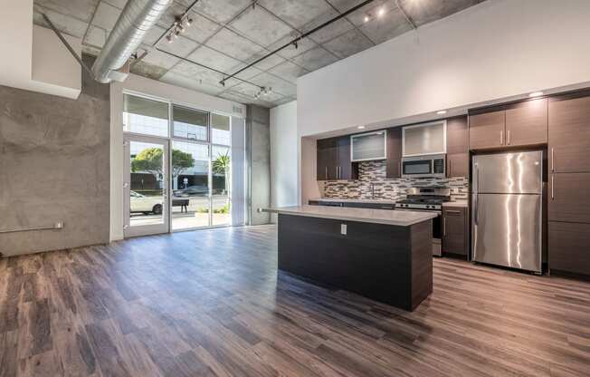 Open kitchen and living/work space in a Live and Work apartment at 1400 FIG Apartments in Los Angeles, California.