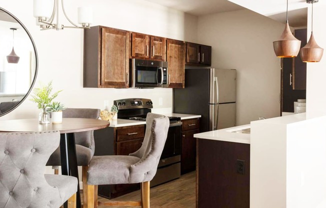 a kitchen and dining room with a table and chairs at Esplanade District Apartments, Arkansas
