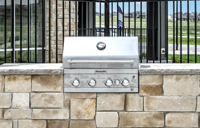 Pool patio with fire pit  and outdoor grill at The Westline at Flanagan Lake in Omaha, NE