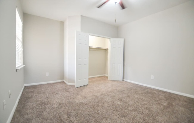 Spacious open concept bedroom with natural light and large closet, located at The Legends at Eagle Mountain Lake -A beautiful lakeside community.