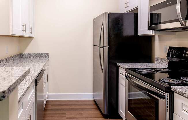 a kitchen with stainless steel appliances and white cabinets