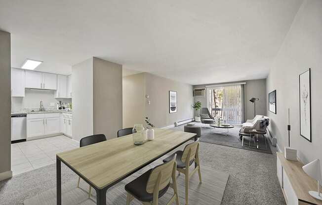 Model Living Room with Carpet and View of Kitchen/Dining Area at Middlesex Crossing Apartments in Billerica, MA.