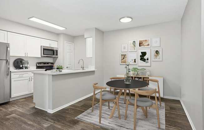 Model Dining Room and Kitchen Area with Wood-Style Flooring at Grand Pavilion Apartments in Tampa, FL.